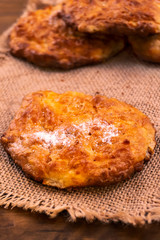 Round biscuits with powdered sugar sprinkles, laid on a cloth of linen.