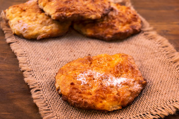 Cookies baked in the oven until golden  brown, sprinkled with powdered sugar on a linen napkin.