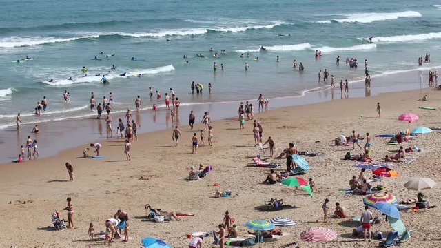 a crowded beach, playa de liencres, in galicia, spain in the summer
