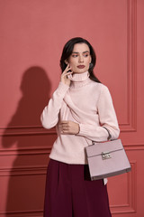 Model posing in studio in trendy clothes
