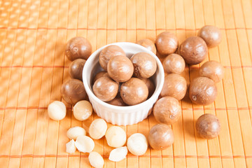 Macadamia nuts on wooden table (Macadamia integrifolia)