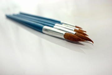 brush for painting, group of objects on a light background. close-up