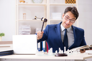 Young lawyer playing chess to train his court strategy and tacti