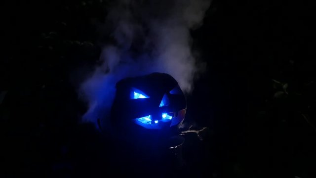 Blue eyes pumpking in Halloween Horror Scene