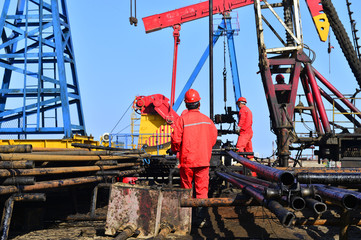 Naklejka premium The oil workers in the job