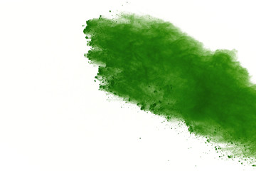 Freeze motion of Green powder exploding on white background.