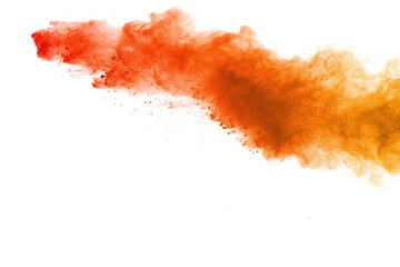 Abstract of colored powder explosion on white background. Orange powder splatted isolate. Colorful...