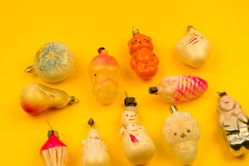 Old fur-tree toys on a yellow background