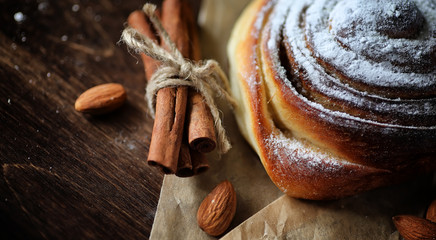 Pie with cinnamon and apples on a wooden table. Fresh pastry wit