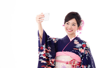 Fototapeta premium portrait of young asian woman wearing purple kimono on white background
