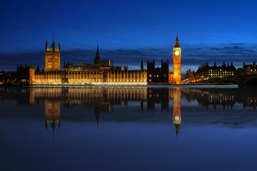 Big Ben and Houses of Parliament Light up at Twilight Reflect Water in Thames River London United Kingdom
