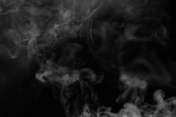 White smoke on a black background. Texture of smoke. Clubs of wh