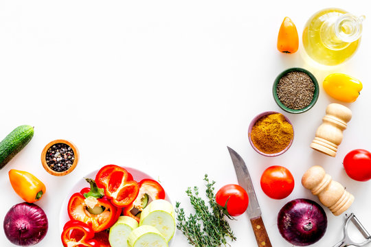 Vegetarian Food Concept. Set Of Vegetables For Stew. Squash, Bell Pepper, Tomato, Spices, Oil On White Background Top View Copy Space