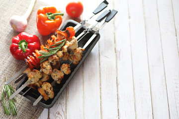 Kebab cooked on metal skewers with vegetables