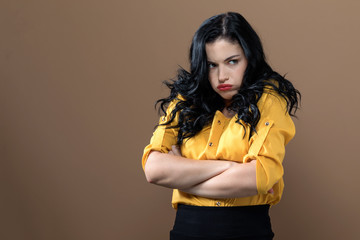 Angry young woman on a solid background