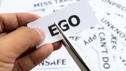 Ego text or word meaning on paper in hand holding