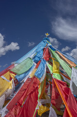 Tibetan prayer flags against sky and clouds in Qinghai, China