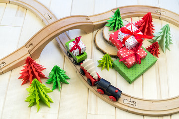 toy wooden train carries a box with gift the child