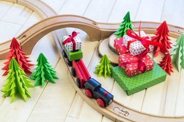 toy wooden train carries a box with gift the child