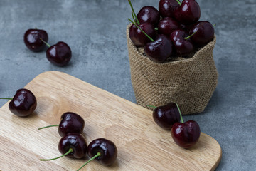 Cherries on a wooden cutting board.