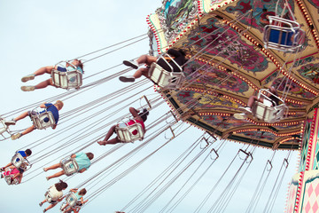 Fair Swing ride with kids © illuminating images