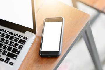 Smartphone mockup on modern white office desk work table and laptop