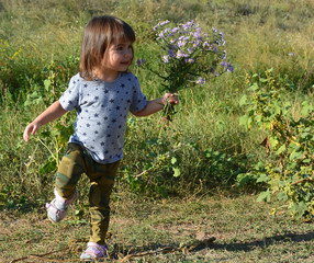 little girl runs on meddow