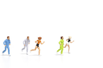 Fototapeta na wymiar Miniature people running on white background , Healthy lifestyle and sport concepts. 