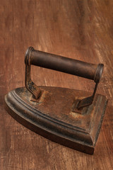 A photo of a vintage iron on a dark background with copyspace