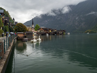 Fototapeta premium Hallstatt village with fog and clouds, World Heritage, Hallstatt mountain village in the Austrian Alps at beautiful light in Summer, Hallstatt, Austria. August, 2018