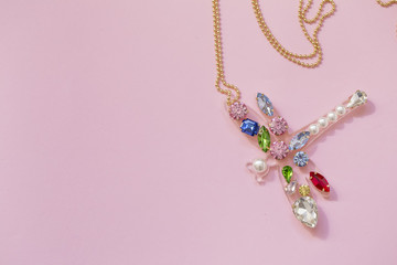 Pendant dragonfly isolated on pink background. Copyspace. Top view