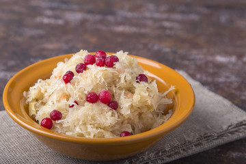 Sauerkraut with berries in a plate. Homemade sauerkraut