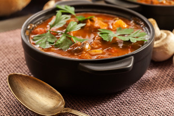 Stew soup with meat, potatoes, mushrooms and red pepper