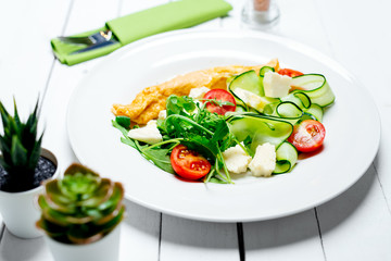 Omelet with vegetables and cherry tomatoes