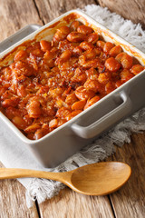 Balkan food: baked beans prebranac close-up in a baking dish. vertical