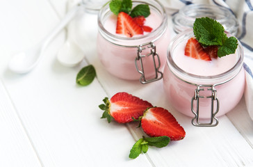 Jars with strawberry yogurt