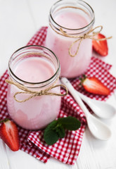 Jars with strawberry yogurt