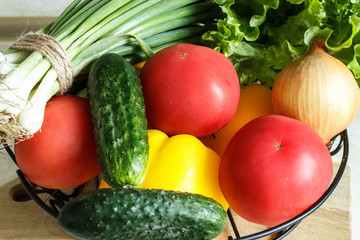 Cucumbers, tomatoes, peppers, duck and lettuce in a basket. Selective focus.