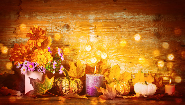 Thanksgiving still life with pumkins, dahlia flowers and candles