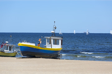 Fishing boat by the sandy beach on the Baltic Sea on a sunny day, Sopot, Poland