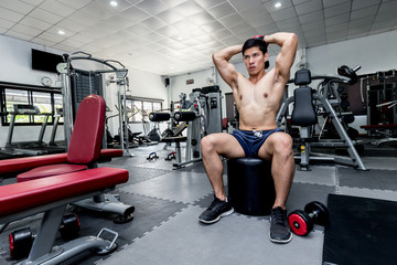 Naklejka na ściany i meble Handsome Attractive Asian men work out with dumbbell in gym for build muscle and strong body,feeling so strong and powerful,Bodybuilder Concept