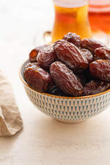 Fresh Medjool Dates in a bowl. Ramadan kareem. White background. Turkish style. Copy space.