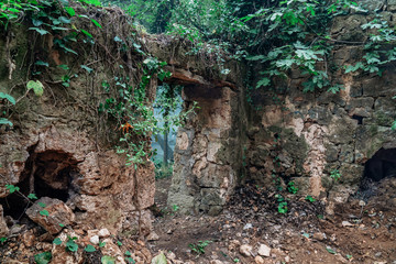 old abandoned stone gate in forest.Entrance of gothic ruins