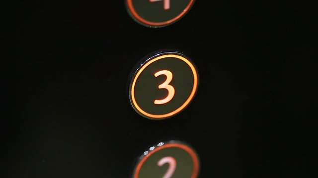 Child pushing button of third floor in modern elevator. Real time full hd video footage.