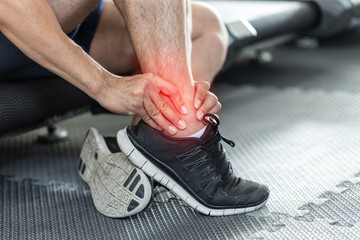 Asian man injury ankle pain after training running workout in gym feeling so pain,Healthcare Concept - obrazy, fototapety, plakaty