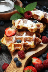 Traditional belgian waffles with fresh mint, sugar and raspberries.