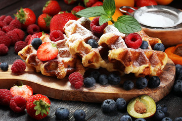 Traditional belgian waffles with fresh mint, sugar and raspberries.