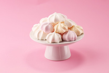 Obraz na płótnie Canvas Meringue. Crispy white and pink twisted meringue. Concept love of sweet