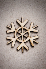 Wooden snowflake on craft paper