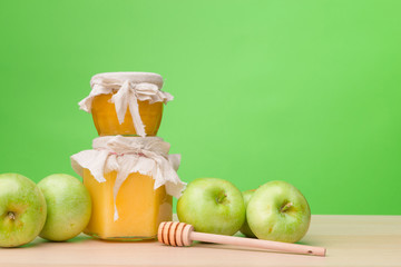 Jewish holiday Rosh Hashanah background with honey and apples on wooden table.